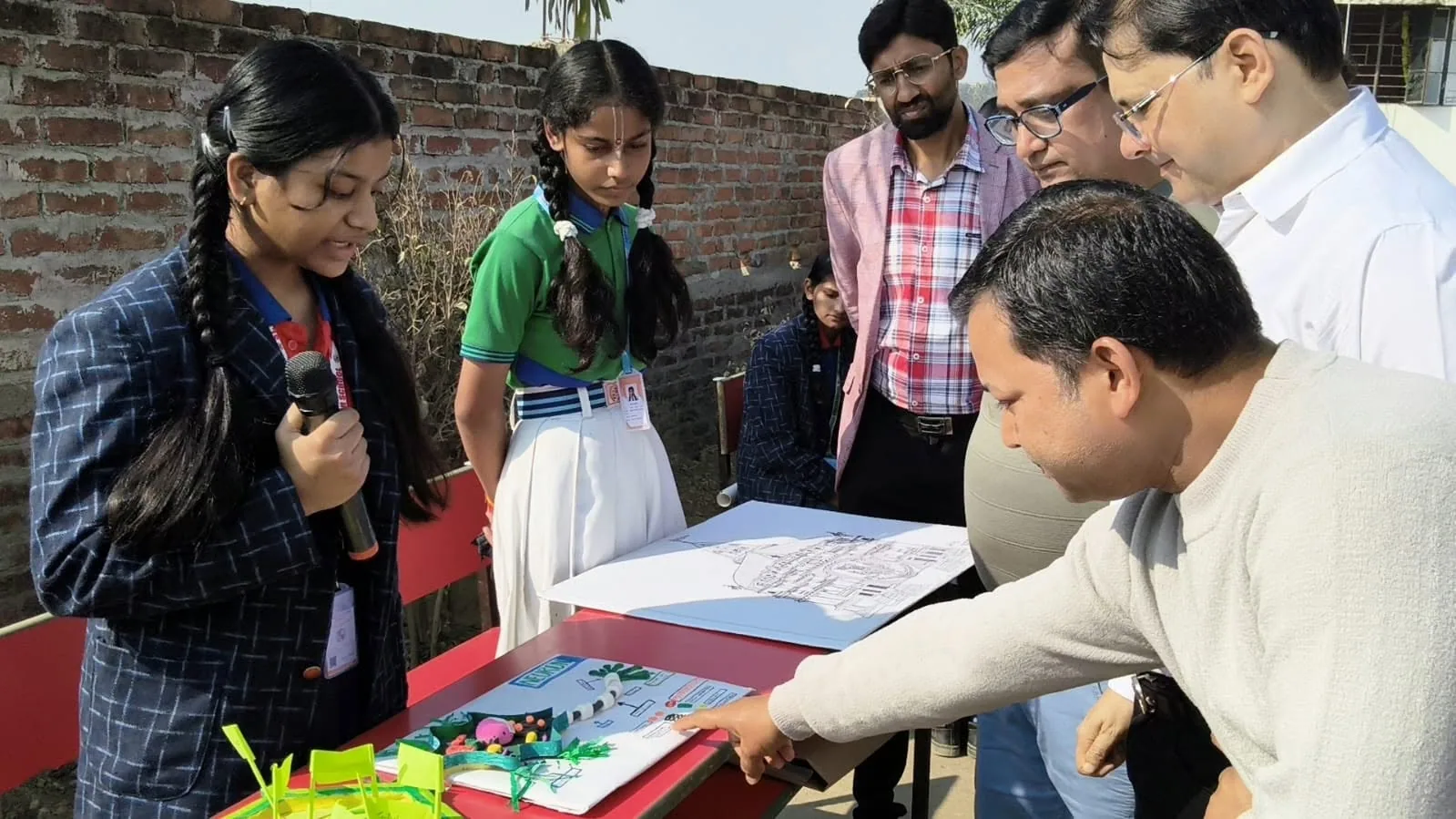 Visitors examining student projects at the school science exhibition