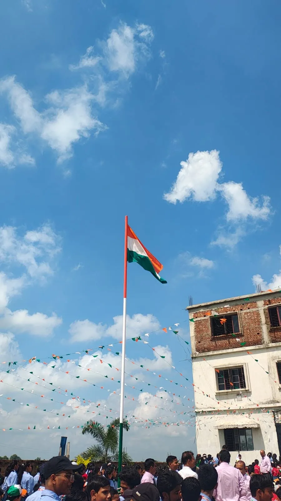 The national flag flying above the school building against a blue sky